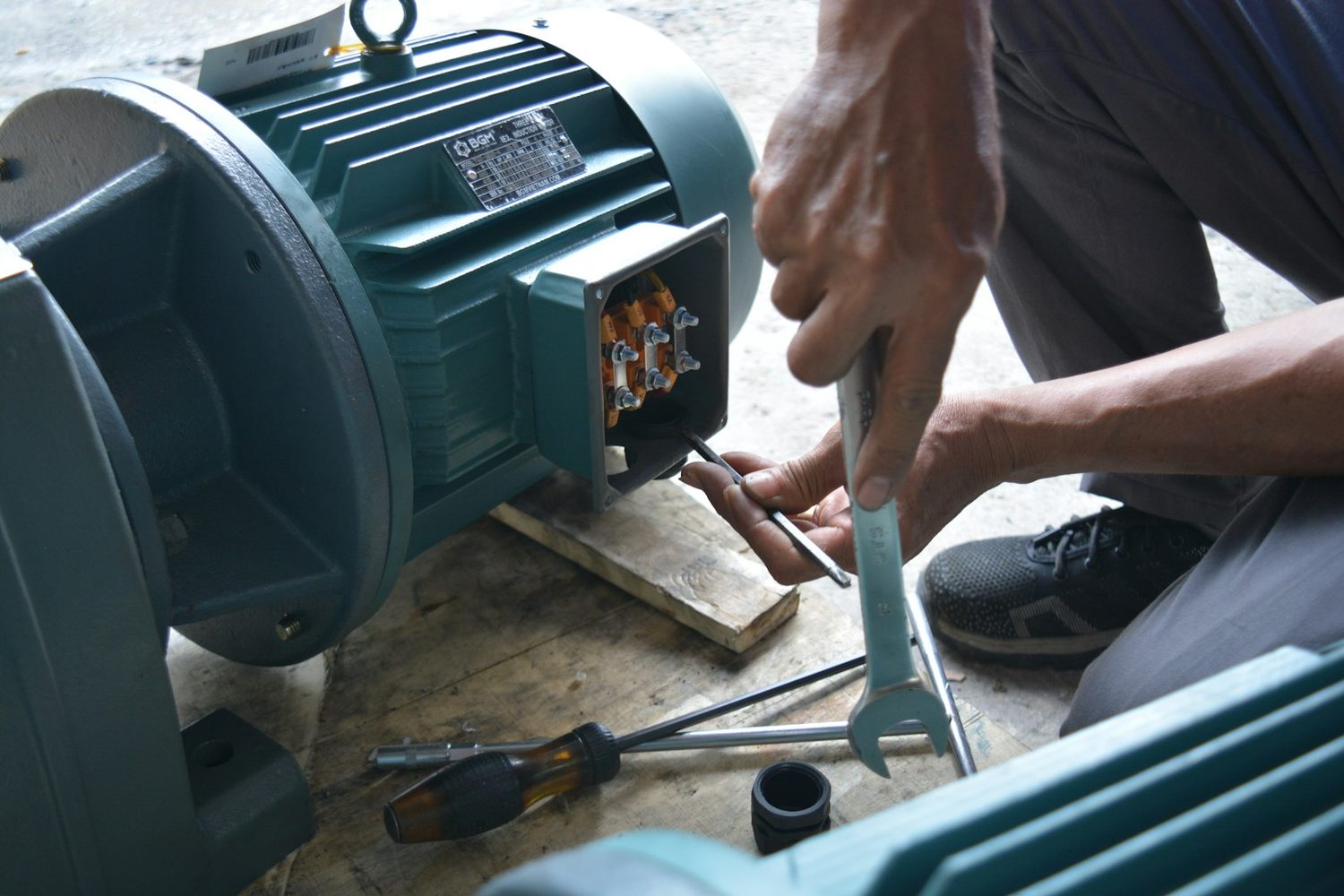 Technician repairing a pool pump motor in Marin
